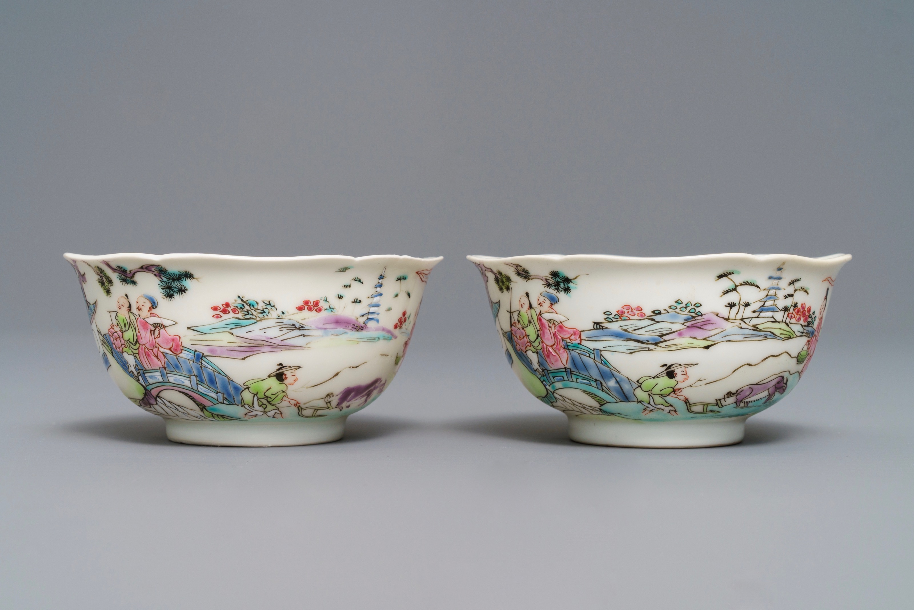 A Pair Of Chinese Famille Rose Cups And Saucers With Figures In A