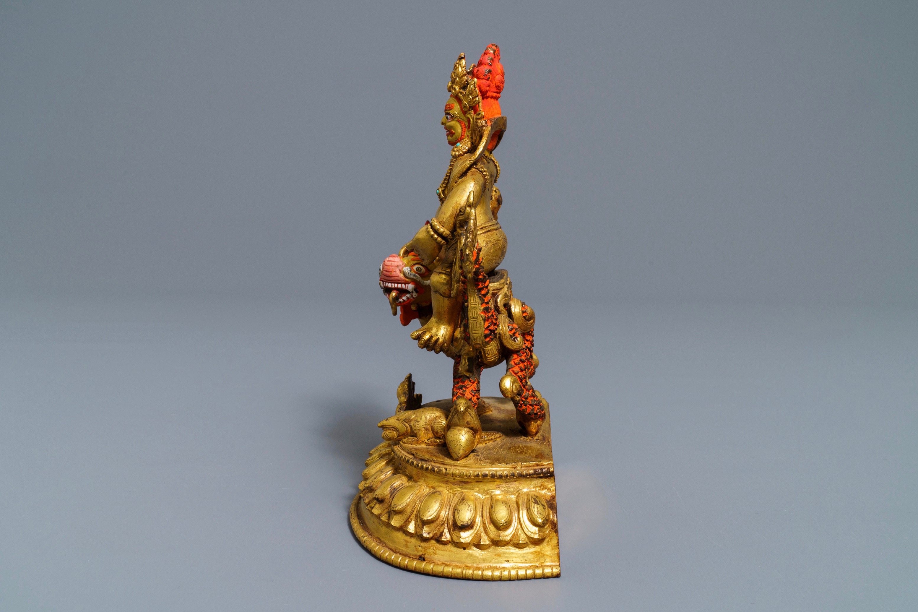 A Sino Tibetan Painted Gilt Bronze Figure Of Jambhala On A Dragon