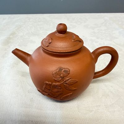 A Chinese Yixing stoneware teapot and cover with floral relief design — photo 1
