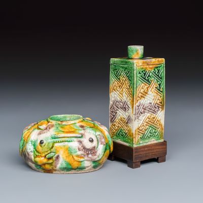 A Chinese famille verte sancai biscuit 'Crab' water pot and a 'Swastika' square bottle on a later wooden stand, Kangxi