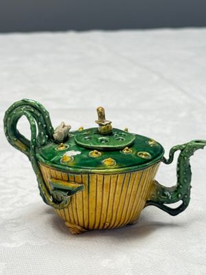 A Chinese famille verte sancai biscuit 'Lotus' teapot on a later wooden stand — photo 3