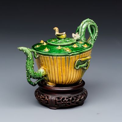 A Chinese famille verte sancai biscuit 'Lotus' teapot on a later wooden stand, Kangxi