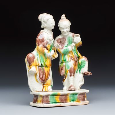 A Chinese famille verte sancai biscuit 'Merry Music Making' group, Kangxi