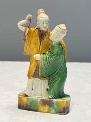A Chinese famille verte sancai biscuit group of a man embracing a lady — photo 1