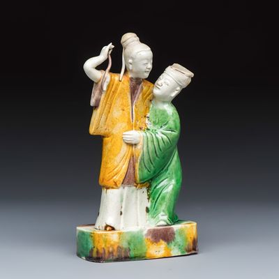A Chinese famille verte sancai biscuit group of a man embracing a lady, Kangxi/Yongzheng