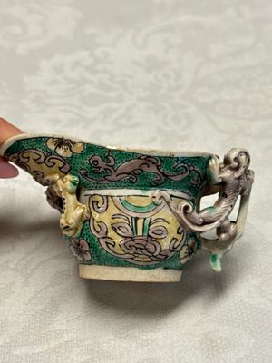A Chinese famille verte sancai biscuit libation cup and a model of a shoe — photo 14