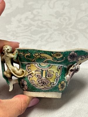 A Chinese famille verte sancai biscuit libation cup and a model of a shoe — photo 17