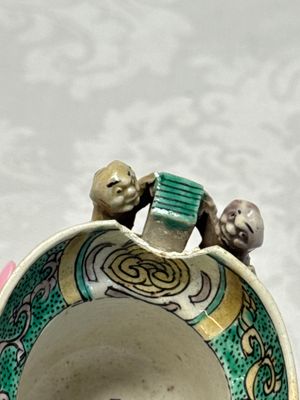 A Chinese famille verte sancai biscuit libation cup and a model of a shoe — photo 23