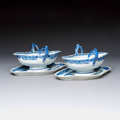 A pair of Chinese blue and white handled sauce boats and stands with pagodas along a river, Qianlong