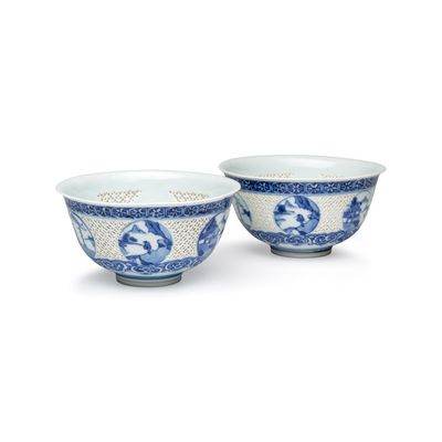 A pair of Chinese blue and white reticulated 'Linglong' bowls with landscape panels, Transitional period