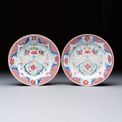 A pair of Chinese famille rose 'Winged Putti' plates, Yongzheng/Qianlong