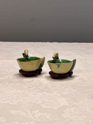 A pair of Chinese famille verte sancai biscuit duck-and-lotus-form water droppers on later wooden stands — photo 1