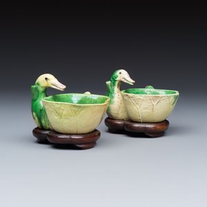 A pair of Chinese famille verte sancai biscuit duck-and-lotus-form water droppers on later wooden stands — photo 1