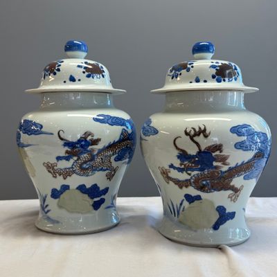 A pair of Chinese underglaze-blue, copper-red and celadon-glazed 'Dragon and Tiger' vases and covers — photo 1