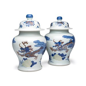A pair of Chinese underglaze-blue, copper-red and celadon-glazed 'Dragon and Tiger' vases and covers — photo 1