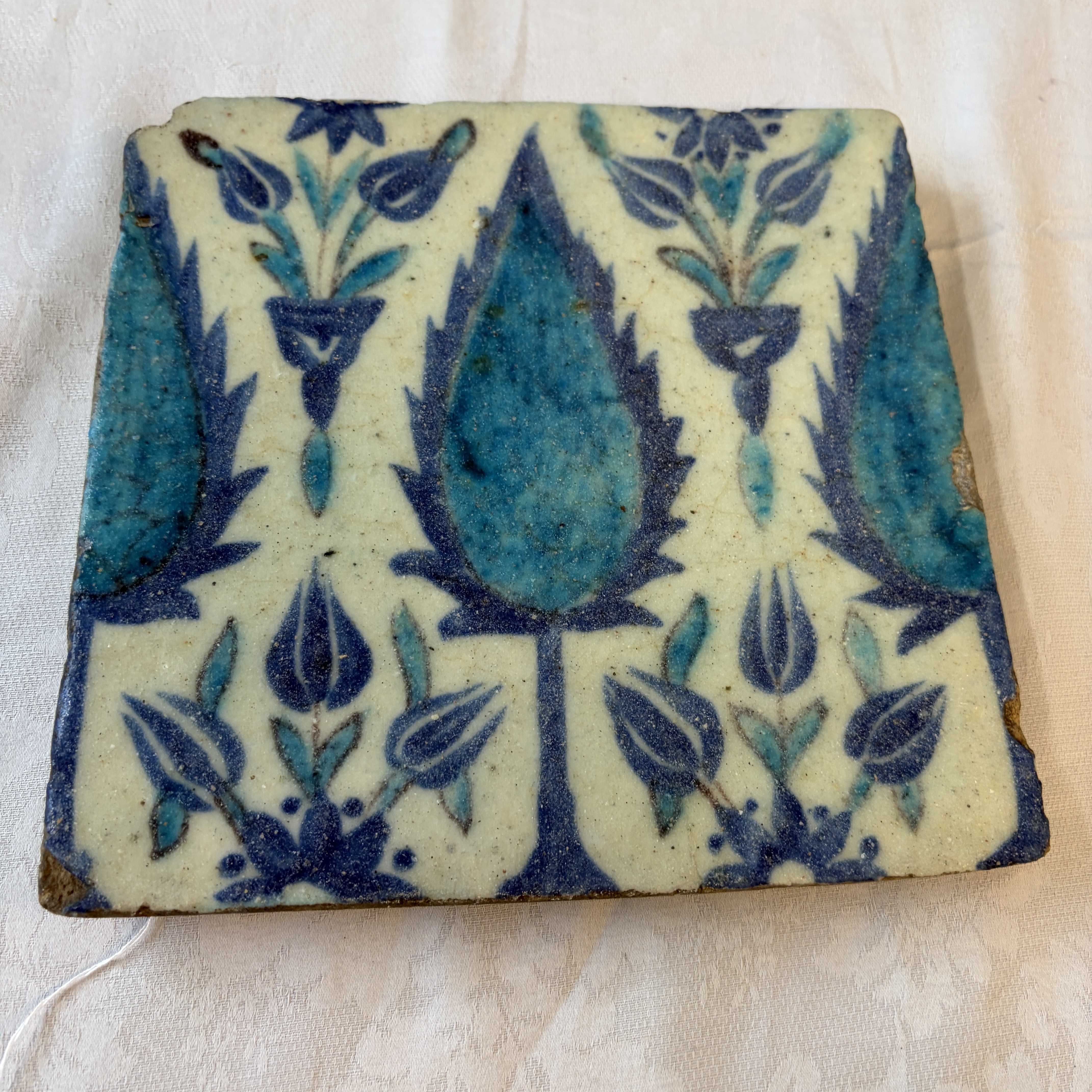 A blue and turquoise Damascus pottery tile with cypress trees — photo 1