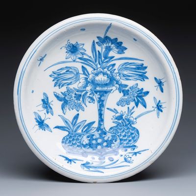 A blue and white Dutch Delft chinoiserie dish with flower vases and insects, 17th C.