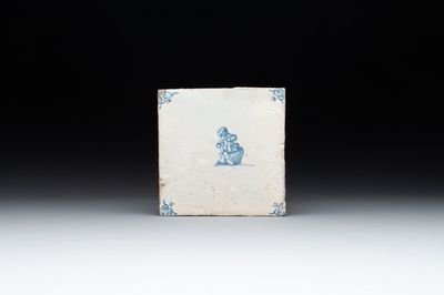A blue and white Dutch Delft 'lady and pooping child' tile , 17th C.