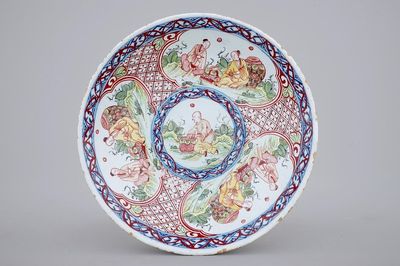 A blue and white Dutch Delft overdecorated plate with chinoiserie, 18th C.