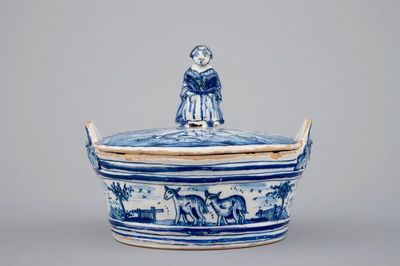 A blue and white Dutch Delftware butter tub with a lady-shaped finial, 18th C.