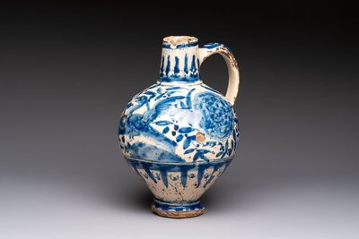 A blue and white Portugese faience jug with a bird among flowering branches, 17th C.
