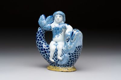 A blue, white and yellow Dutch Delft ewer in the shape of a putto on a dolphin, 18th C.