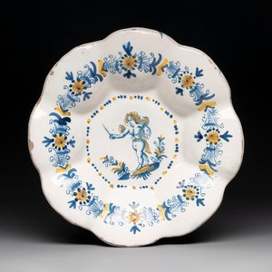 A blue, white and yellow Dutch Delftware dish with a putto, Delft or Haarlem, 17th C. — photo 1