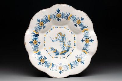 A blue, white and yellow Dutch Delftware dish with a putto, Delft or Haarlem, 17th C.