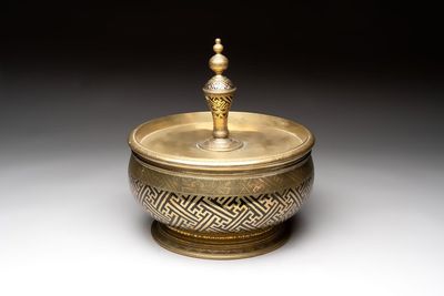 A brass betel bowl and cover with black-enamelled and engraved design, Indonesia, 19th C.