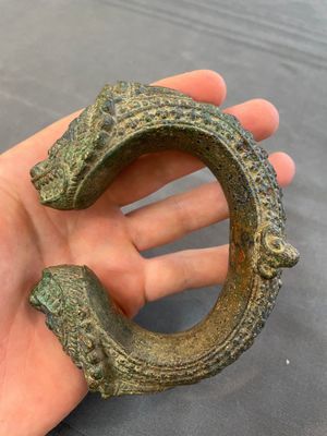 A bronze mirror, a bracelet with a royal or noble emblem and a bronze bracelet with two tiger heads, Cambodia, 12th C. — foto 12