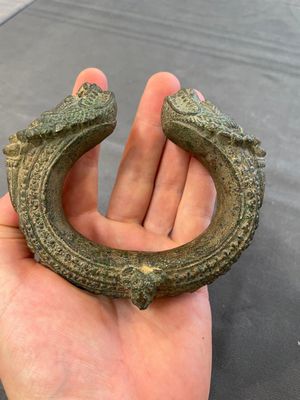 A bronze mirror, a bracelet with a royal or noble emblem and a bronze bracelet with two tiger heads, Cambodia, 12th C. — foto 10