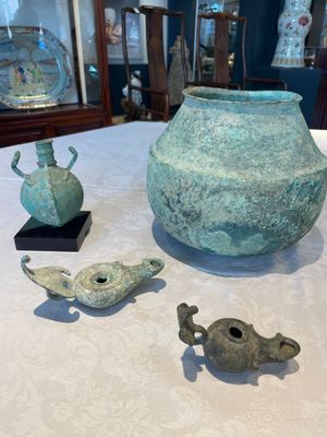 A bronze urn, a bronze canteen with relief design and a pair of bronze oil lamps, Etruscan and Roman civilizations, 9th C. B.C/5th C. — photo 1