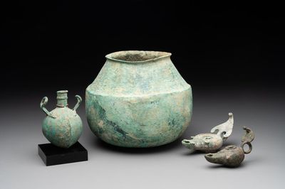 A bronze urn, a bronze canteen with relief design and a pair of bronze oil lamps, Roman Empire, 9th C. B.C/5th C.