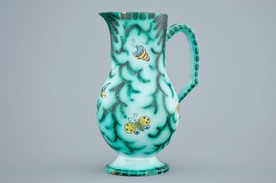 A Brussels faience water jug with butterflies and caterpillars, 18/19th C.