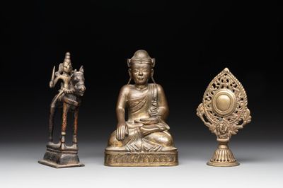 A Burmese gilt bronze Buddha, an Indian bronze Shiva on horseback and and a Nepalese Melong ritual mirror with Ganesh, 18/19th C.