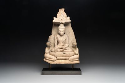 A Burmese limestone stele with Buddha and two attendants with traces of gilding, 19th C.