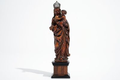 A carved and partial gilt boxwood Madonna with child on rosewood base, 16/17th C.