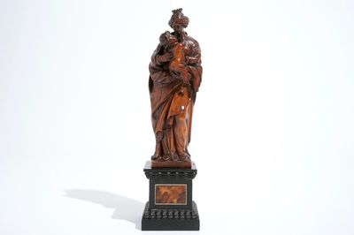 A carved boxwood Madonna with child on tortoise veneer base, 17th C.