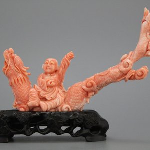 A carved Chinese red coral group of a boy on a dragon, 19/20th C. — photo 1