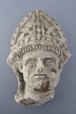 A carved stone head of a saint, 16th C.