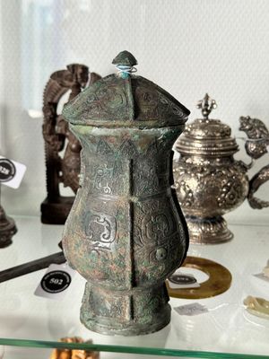A Chinese archaic bronze food vessel and cover with taotie design, 'zhi 觶', Shang — photo 13