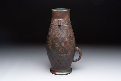 A Chinese archaic bronze inscribed wine vessel with scale design, 'hu 壺', Zhou