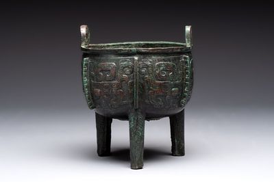 A Chinese archaic bronze tripod food vessel with 'taotie' design, 'ding 鼎', Western Zhou