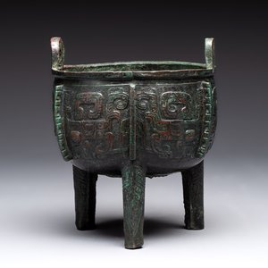 A Chinese archaic bronze tripod food vessel with 'taotie' design, 'ding 鼎', Western Zhou — photo 1