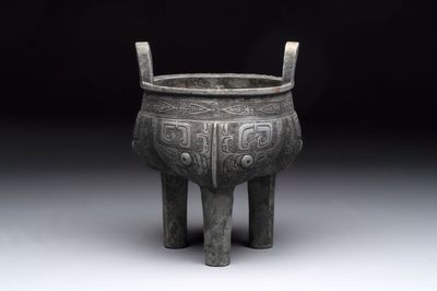 A Chinese archaic bronze tripod food vessel with 'taotie' design, 'ding 鼎', Western Zhou
