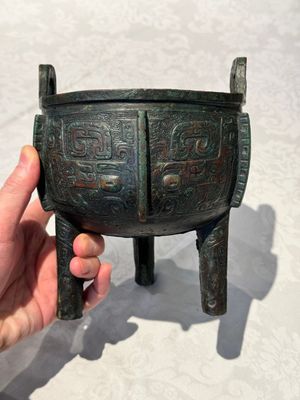 A Chinese archaic bronze tripod food vessel with 'taotie' design, 'ding 鼎', Western Zhou — photo 1