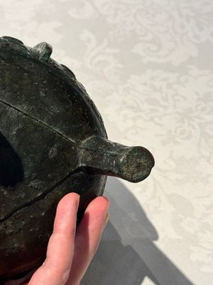 A Chinese archaic bronze tripod food vessel with 'taotie' design, 'ding 鼎', Western Zhou — photo 8