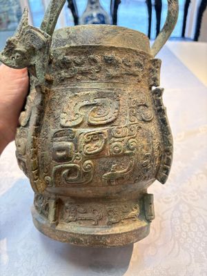 A Chinese archaic bronze wine vessel and cover with Taotie design, You 卣, late Shang — photo 11