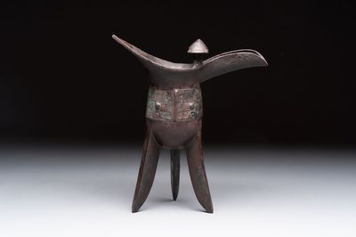 A Chinese archaic bronze wine vessel with taotie design, 'jue 爵', Zhou