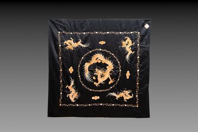 A Chinese black-ground embroidered silk panel with a four-clawed dragon, 19th C.